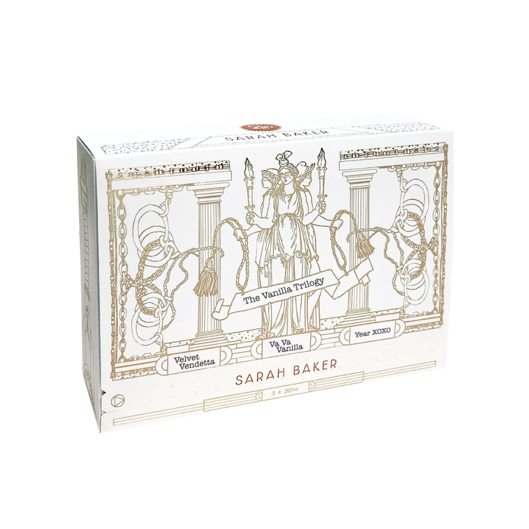 A Vanilla Trilogy white gift box with black illustration and orange Sarah Baker lettering.