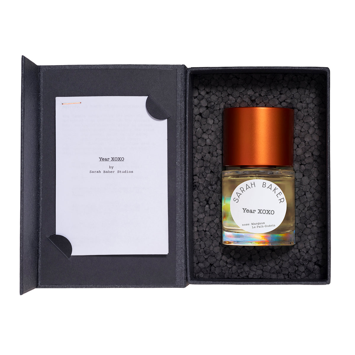 Sarah Baker Year XOXO perfume bottle inside its open black presentation box